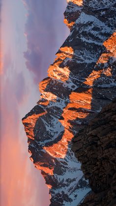 the mountains are covered in snow as the sun goes down on them and there is no image here to provide a caption for