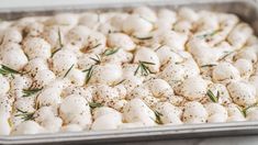 a baking pan filled with mozzarella and rosemary