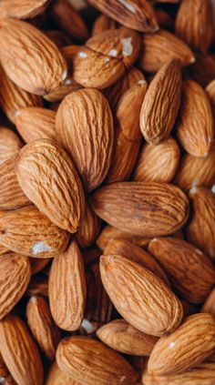 almonds are shown in this close up shot, with the kernels still on them