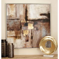 an abstract painting on the wall next to some vases and a gold sculpture in front of it