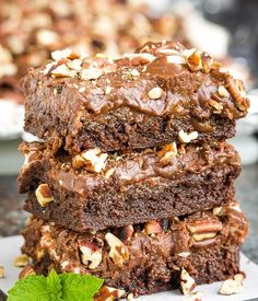 three brownies stacked on top of each other with nuts and chocolate in the middle