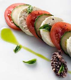 a white plate topped with cucumber and tomato slices