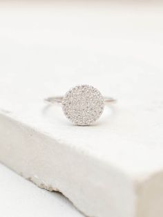 "Our disc ring is simple and elegant. It is made with fine and tiny CZ's to get the ultimate shine and sparkle. This ring looks great on it's own or stacked with our other rings! Ring is Small and Dainty! Material: Brass Color: Silver - Rhodium Plate Setting: Micropave Height: approximately 1/2\" Listing is for one Silver colored ring. Images are meant to show you how the ring fits/looks on the hand. All other jewelry in images are available in my shop or my website. Feel free to contact me if y Minimalist Diamond Ring With Brilliant Cut, Sparkling Stackable Rings Gift, Dainty Cubic Zirconia Cluster Ring, Dainty Cluster Ring With Halo Setting, Minimalist White Gold Crystal Ring With Round Cut, Minimalist Single Cut Diamond Rings, Modern Diamond White Rings, Everyday White Gold Diamond Ring, Minimalist Cubic Zirconia Diamond Ring With Pave Setting