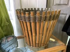 a bamboo basket sitting on top of a glass table