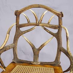 a chair made out of antler branches and wicker