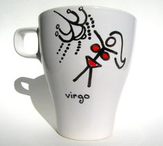 a white coffee cup with the word vigo painted on it's side and red eyes