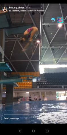 an image of a man jumping into the water from a diving platform in a swimming pool