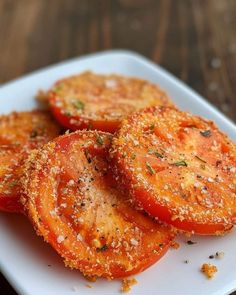 sliced tomatoes on a white plate with seasoning