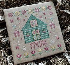 a cross stitch pattern with a house on it