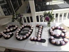 a table topped with cupcakes covered in frosting and the word love spelled out