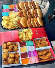 two trays filled with different types of food next to each other on a table