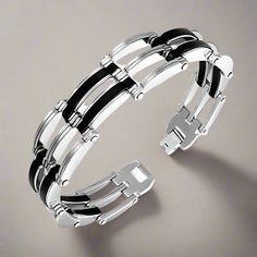 Make a bold statement with this Geometric Men's Link Bracelet! Crafted from the finest 316L stainless steel and featuring thick black rubber links, this bracelet combines rugged durability with sleek style. Its textured geometric design creates an eye-catching, modern look that’s perfect for everyday wear. Whether you're dressing up or keeping it casual, this bracelet is the perfect addition to any outfit. An ideal gift for the man who loves fashion-forward accessories. Hypoallergenic and comfortable for daily wear. Material: 316L Highest Quality Stainless Steel (hypoallergenic) & thick rubberWeight: 41.80 grams (1.46 ounce)Width: 1.40 cm (0.55 inch)Length: 20.50 cm (8.07 inch)Comes in a gift box(Regular Price $105.00) Perfect for gifting or treating yourself to a high-quality, trendy acce Manly Jewelry, Mens Link Bracelet, Biker Jewelry, Men's Bracelet, Sleek Style, Sleek Fashion, Urban Style, Trendy Accessories, Black Rubber