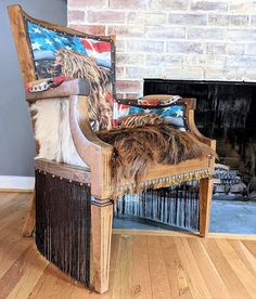 an old chair with some fur on it in front of a fire place and fireplace