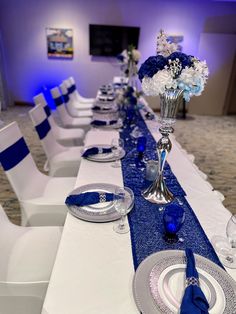 the table is set with white and blue place settings