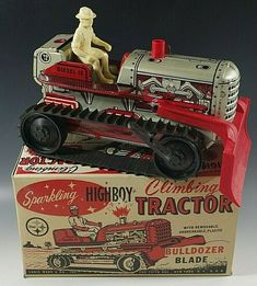 an old fashioned toy truck with a woman sitting on the front in it's box