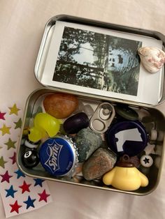 an open tin can filled with rocks and magnets