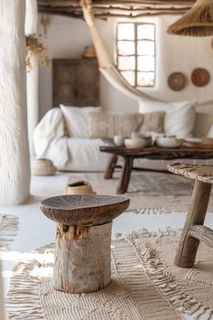 a rustic living room with white walls and natural wood furniture in the background, including a hammock hanging from the ceiling