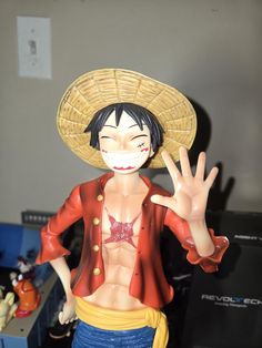 an action figure wearing a sombrero and holding his hand up in the air