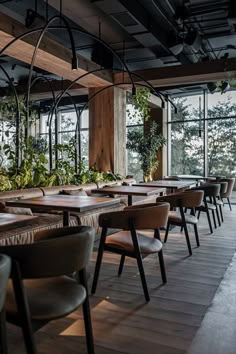 an empty restaurant with wooden tables and chairs