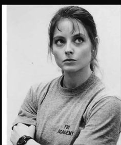 a black and white photo of a woman with her arms crossed