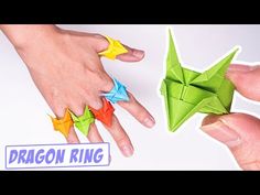 two hands are holding origami stars and the other hand is pointing at them