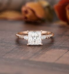 a princess cut diamond engagement ring with three side stones