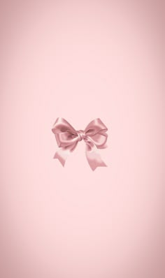 a pink background with a large bow on the top and bottom part of it's ribbon