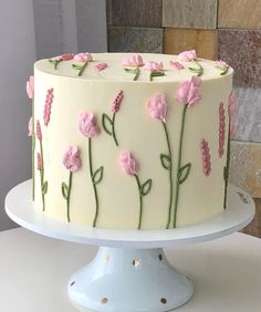 a white cake with pink flowers on it