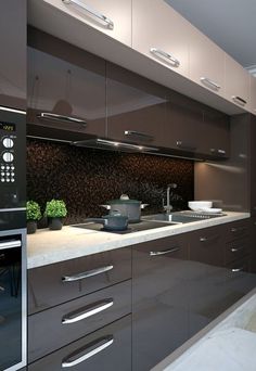 a modern kitchen with stainless steel appliances and dark wood cabinetry, along with white countertops