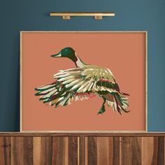 a painting of a duck is hanging on the wall