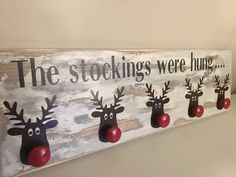 a wooden sign with reindeer heads on it that says, the stockings were hung up