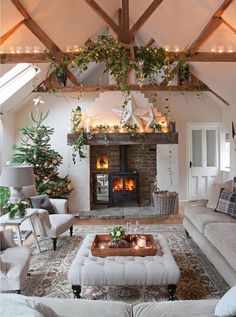 a living room filled with furniture and a fire place in the middle of a room