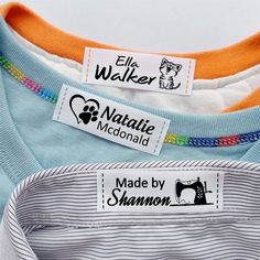 three different colored shirts with labels on them