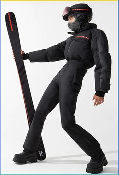 a man in ski gear holding a snowboard