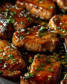 some meat is cooking in a skillet with sauce and parsley on the side