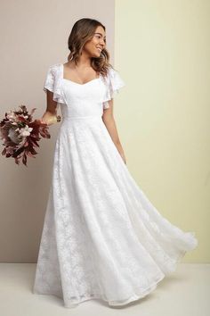 a woman in a white dress holding a bouquet