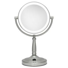 a round mirror sitting on top of a metal stand