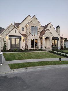 a large house with lots of windows and landscaping