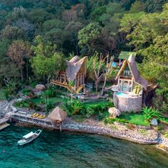 an aerial view of a house on the water