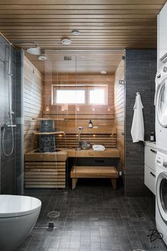 a bathroom with a washer and dryer in it