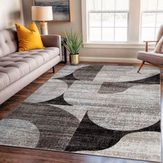 a living room with a couch, chair and rug