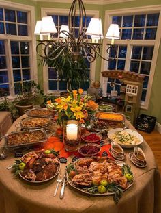 a dining room table covered in lots of food