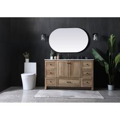 a white toilet sitting next to a wooden cabinet with mirror on it's side