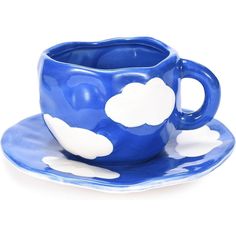 a blue cup and saucer with clouds on it