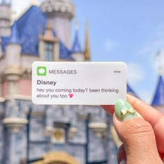 someone is holding up a card in front of a castle