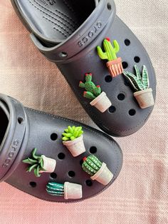 a pair of crocs with cactus decorations on them