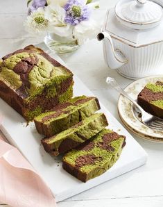 slices of green cake sitting on top of a white cutting board