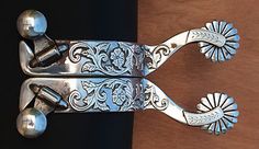 a pair of silver scissors sitting on top of a wooden table