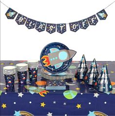 a space themed birthday party with cups and plates