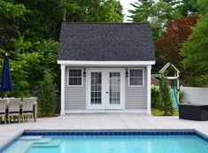 a small pool house next to a swimming pool